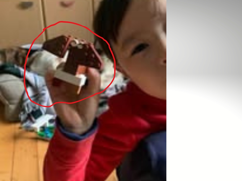 child holding Lego dog creation during imaginative play